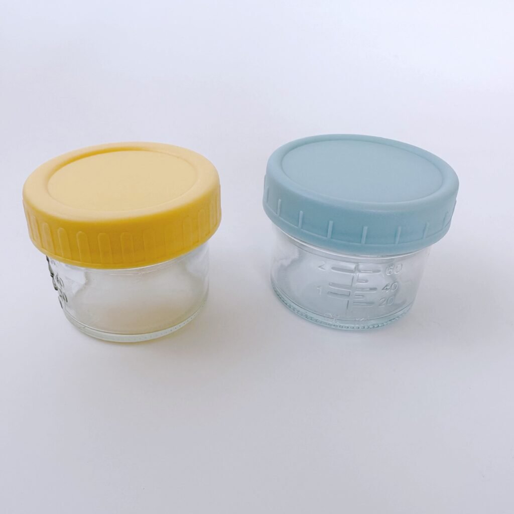 macaron-colored airtight plastic mason jar lids in pastel pink, mint, and yellow on glass jars.