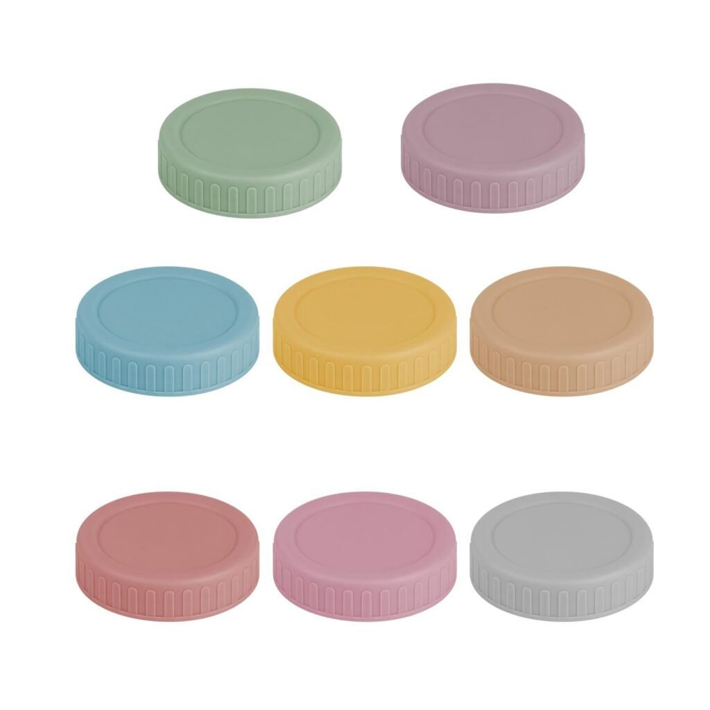 Full assortment of colorful macaron-style plastic lids for mason jars, arranged in a spectrum.